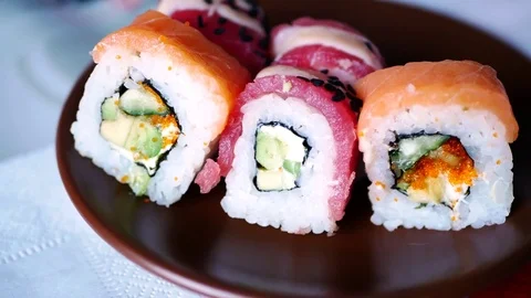Taking one sushi roll from plate. Stock Footage 70674393