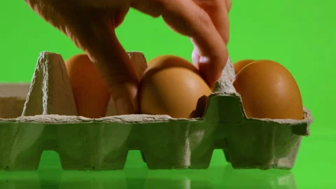Taking or removing eggs from the packaging for cooking. Stock Footage 204163355