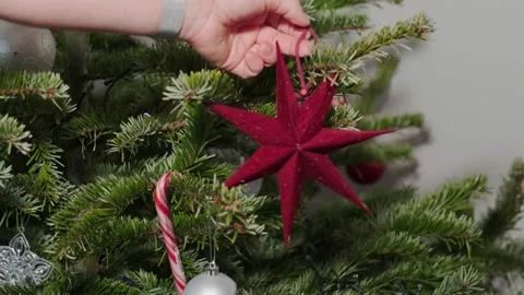 Taking the ornaments of a Christmas tree. Red star. Stock Footage 168835645