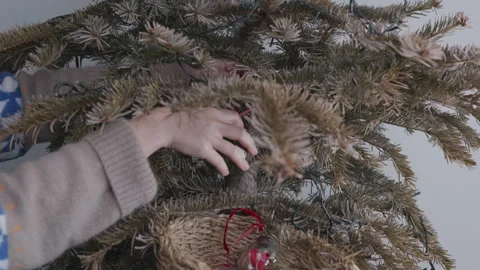 Taking off ornaments from tree, minimalism and post holiday reset Stock Footage 332908710