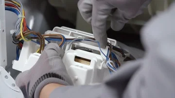 Taking out all the wires from a small device Stock Footage 85835028