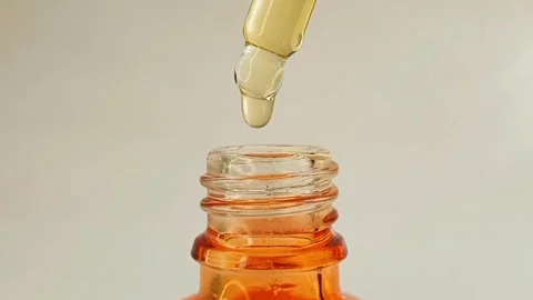 Taking out bottle pipette dropper and dripping lightweight liquid vitamin c Stock Footage 284535068