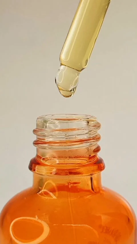 Taking out bottle pipette dropper and dripping lightweight liquid yellow serum Stock Footage 284535282