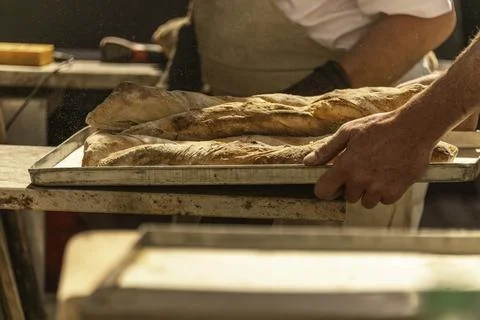 Taking Out The Bread From The Oven Stock Photos