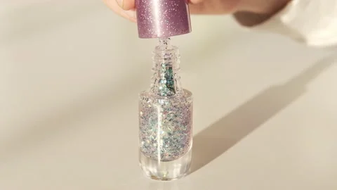 Taking out brush from glitter nail polish bottle. Shine shellac gel polish Stock Footage 170658162
