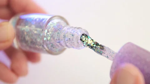 Taking out brush from glitter nail polish bottle. Shine shellac gel Stock Footage 171190143
