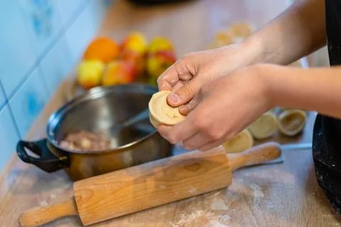 Taking out cooked dumplings from pot with spoon photo Photos
