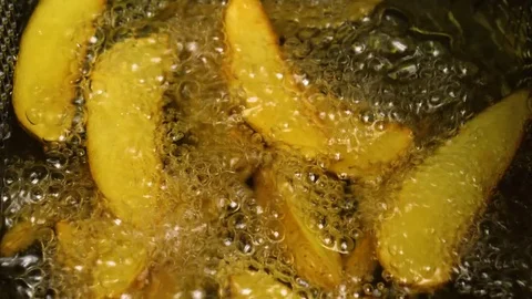 Taking out Fried potatoes in a rural style from boiling oil, 4K 60 FPS Stock Footage 76952668