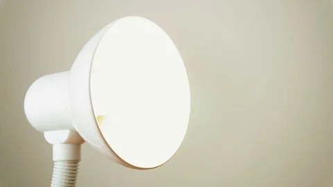 Taking out the LED light bulb which ceased to shine from the white table la.. Video stock 70566386