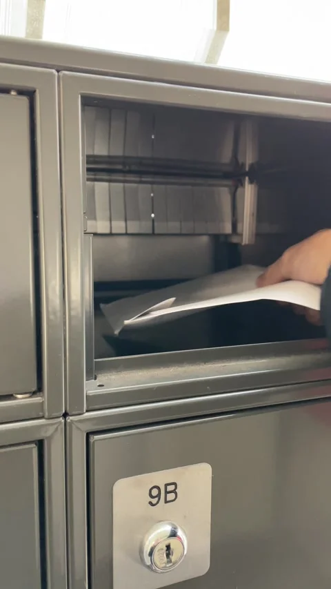 Taking out a mail from apartment mailbox 動画素材 255227241