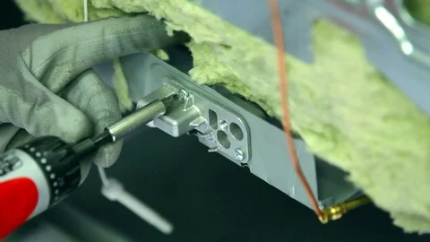 Taking out nails because he needs to take apart the whole stove Stock Footage 75372513