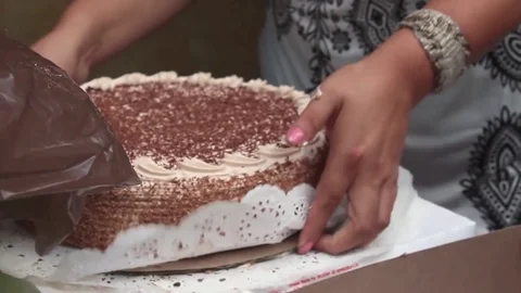 Taking out a new cake out of the box Stock Footage 83499113
