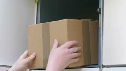 Taking out a parcel from a parcel locker in 4k slow motion 60fps Stock Footage 155900968