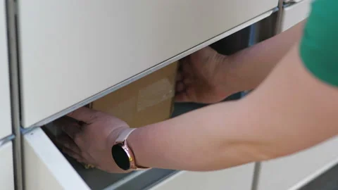 Taking out a parcel from a parcel locker in 4k slow motion 60fps Stock Footage 155901290