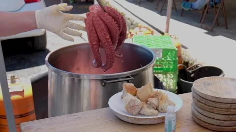 Taking out of the pot a freshly cooked octopus Stock Footage 154436705