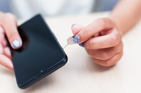 Taking out a sim card from a smartphone Stock Photos