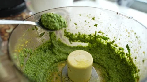 Taking out spoon full of mint paste from blender in kitchen. Kitchen Stock Footage 291843393