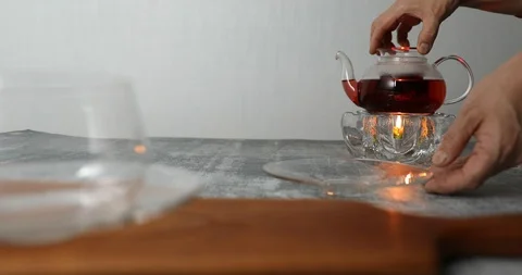 Taking out tea filter with hibiscus petals and rose hip fruits from glass teapot Stock Footage 119765747