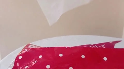 Taking out a tissue from a red square with a white polka dot motif Stock Footage 145562735