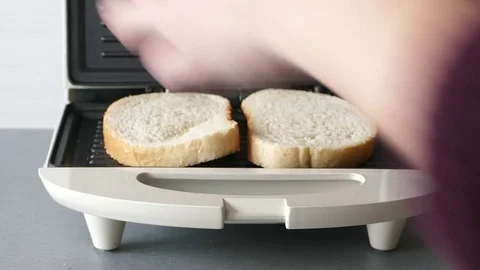 Taking out toasted bread and putting new slices in Stock-Footage 72560179