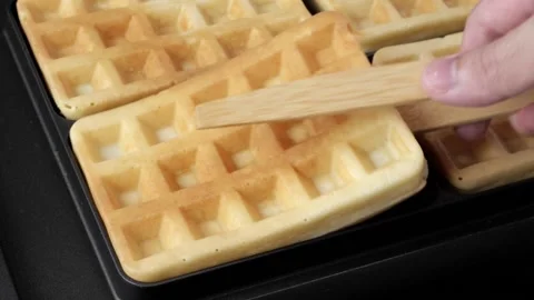 Taking out waffles from the pan/waffle maker Stock Footage 161345431