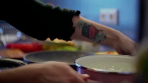 Taking a pan from the stove Stock Footage 85064798