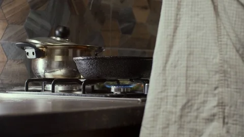 Taking pan from stove Stock Footage 126612279