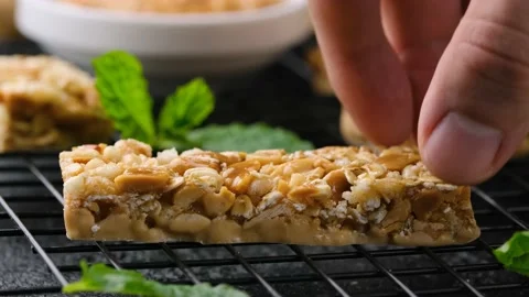 Taking Peanuts butter Cereal Bars with nuts, oat and honey. Healthy Protein Stock Footage 172062682