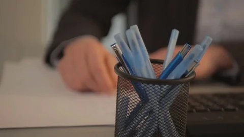Taking a pen from the cup Stock Footage 73022512