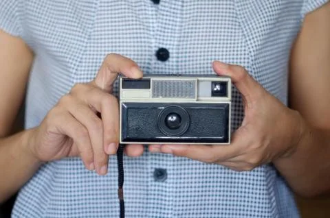 Taking photo with retro camera. Stock Photos