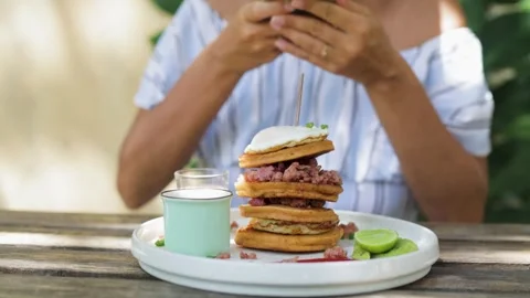 Taking pictures of a stack of pancakes with a poached egg. Stock Footage 269514683