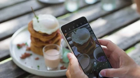 Taking pictures of a stack of pancakes with a poached egg. Stock Footage 269514799