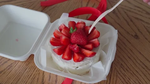 Taking a piece of Asian bento cake with a wooden fork, female caucasian hand Stock Footage 196619247