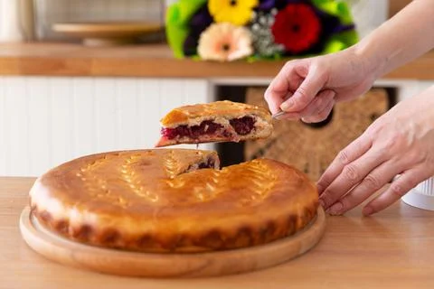 Taking a piece of cherry pie with a spatula. Stock Photos