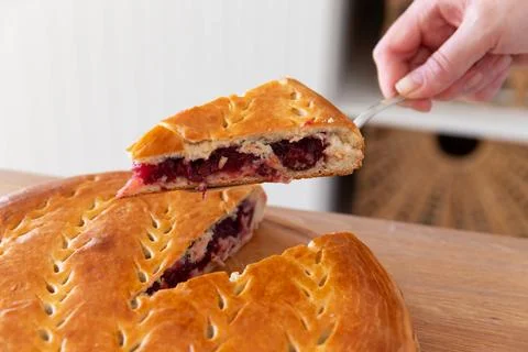 Taking a piece of cherry pie with a spatula. Stock Photos