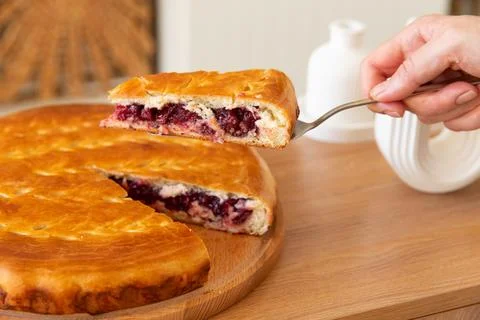 Taking a piece of cherry pie with a spatula. Stock Photos