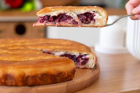 Taking a piece of cherry pie with a spatula. Stock Photos