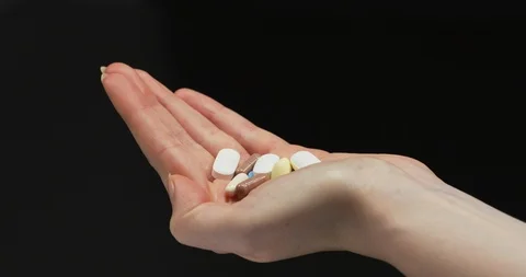 Taking a pill from hand Stock Footage 99750619
