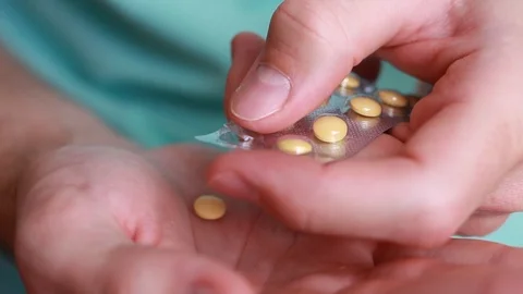 Taking pill from plate pack Stock Footage 86056155