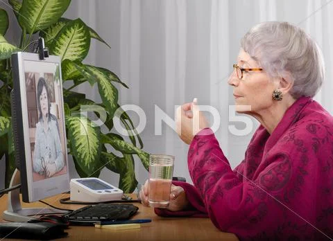 Taking pill under telehealth control Stock Photos