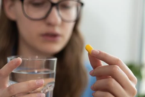 Taking pill while being ill close-up. Stock Photos