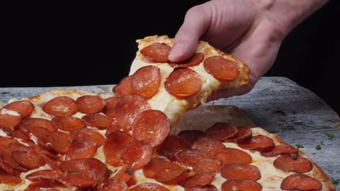 Taking pizza slice from the table. Tasty fast food Hand taking pizza slice. Видео 336586629