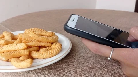 Taking a potato chip on a white plate Stock Footage 146252144
