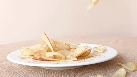 Taking a potato chip on a white plate Stock Footage 146252583