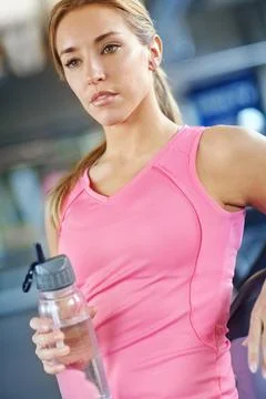 Taking a quick break between workouts. A young woman resting after her workout. Stock Photos
