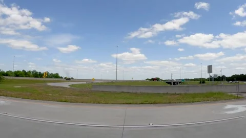 Taking an off ramp off the highway distant bridge cars and smoke Stock Footage 185617982