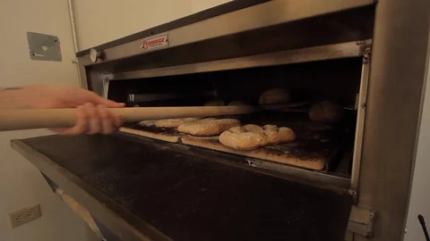 Taking ready bread out of the oven Stock-Footage 130040469