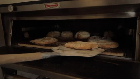 Taking ready bread out of the oven - 02 Stock-Footage 130040531