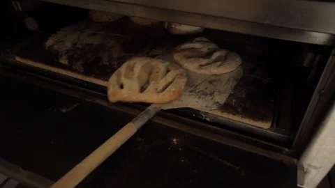 Taking ready bread out of the oven - 03 Stock Footage 130040705