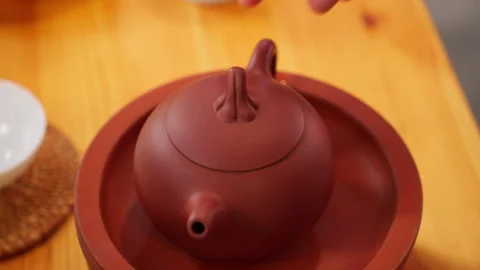 Taking up a red clay teapot Stock Footage 274527378